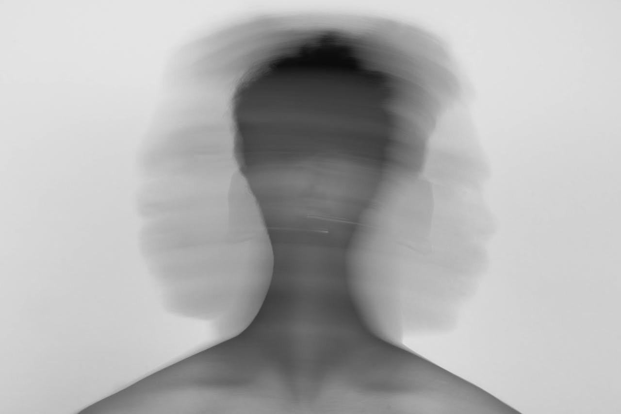 services-03 Abstract black and white portrait with blurred motion conveying emotional stress.