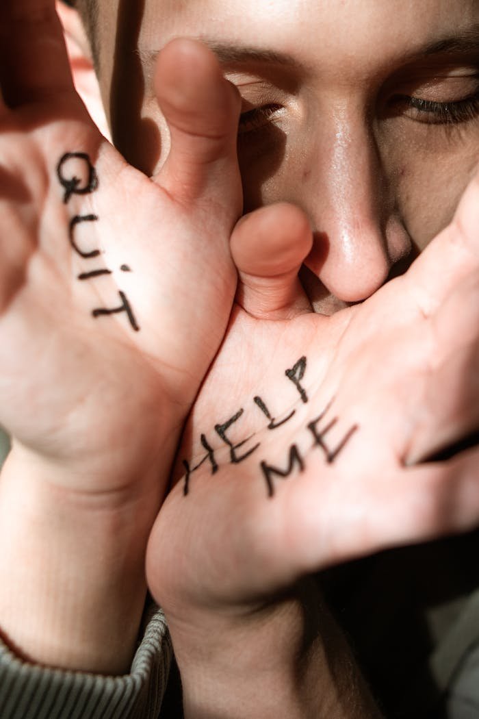 gallery-6 Hands with 'Help Me' and 'Quit' written on them, symbolizing an emotional plea for help in an abusive context.